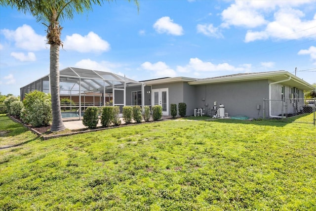 2309 Conway Blvd, Port Charlotte, FL 33952 - back of property featuring stucco siding, french doors, glass enclosure, and an outdoor pool