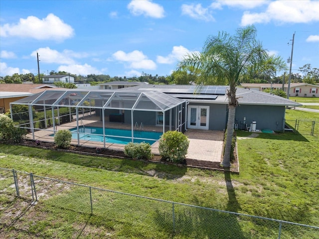 2309 Conway Blvd, Port Charlotte, FL 33952 - rear view of property with french doors, a fenced backyard, an outdoor pool, solar panels, and a patio
