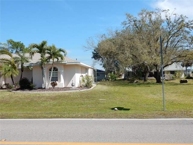 388 Orlando Blvd, Port Charlotte, FL 33954 - view of home's exterior with a yard and stucco siding