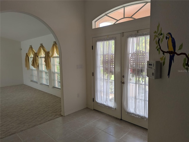 388 Orlando Blvd, Port Charlotte, FL 33954 - carpeted entrance foyer with french doors, tile patterned floors, and arched walkways