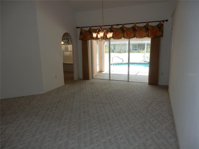 388 Orlando Blvd, Port Charlotte, FL 33954 - spare room featuring a chandelier, carpet floors, and arched walkways