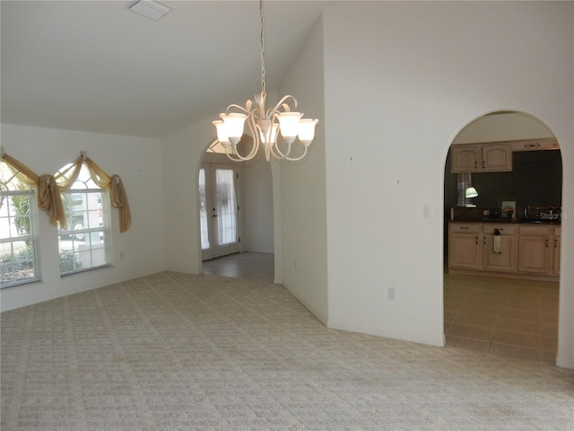 388 Orlando Blvd, Port Charlotte, FL 33954 - unfurnished room with arched walkways, light colored carpet, a chandelier, french doors, and high vaulted ceiling