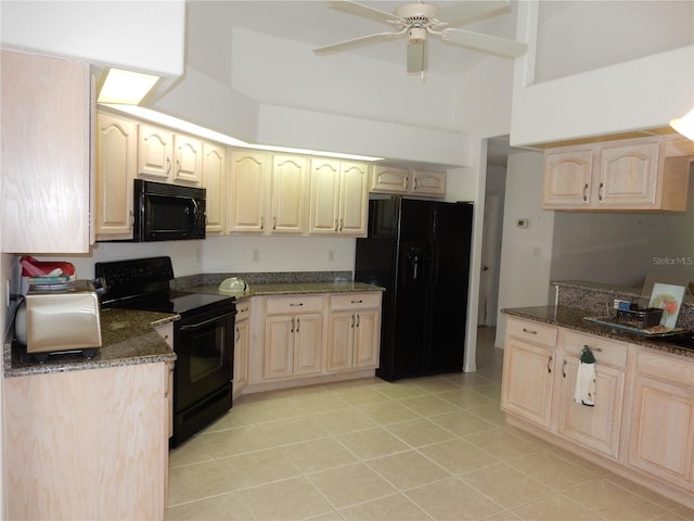388 Orlando Blvd, Port Charlotte, FL 33954 - kitchen with black appliances, light brown cabinetry, dark stone counters, and a towering ceiling