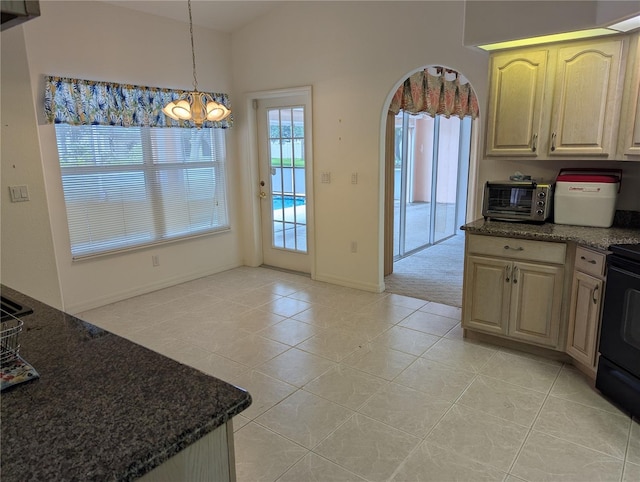 388 Orlando Blvd, Port Charlotte, FL 33954 - kitchen featuring light tile patterned floors, gas stove, a chandelier, dark stone countertops, and pendant lighting
