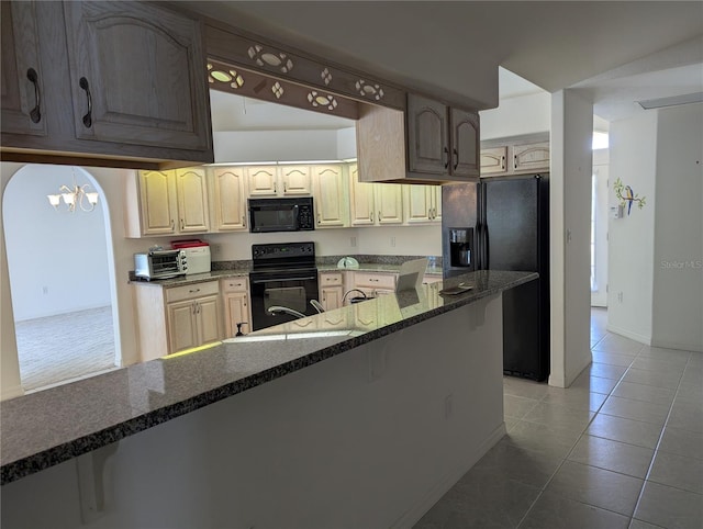 388 Orlando Blvd, Port Charlotte, FL 33954 - kitchen with black appliances, a chandelier, tile patterned flooring, and dark stone counters