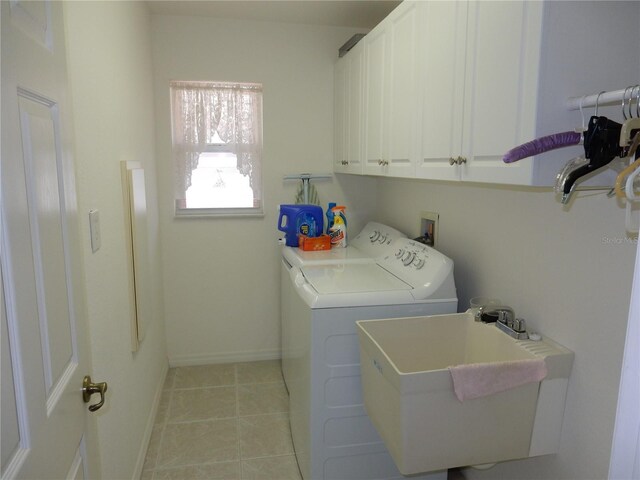 388 Orlando Blvd, Port Charlotte, FL 33954 - laundry room with washing machine and dryer, cabinet space, and light tile patterned floors