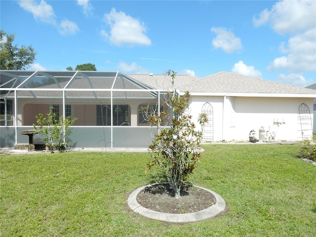 388 Orlando Blvd, Port Charlotte, FL 33954 - back of property with a yard, stucco siding, and glass enclosure