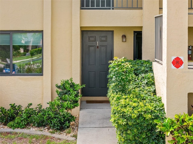 3221 White Ibis Ct Unit D1, Punta Gorda, FL 33950 - view of exterior entry featuring stucco siding