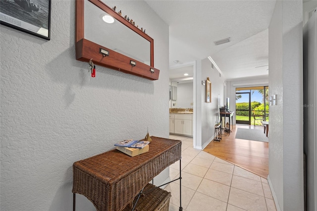 3221 White Ibis Ct Unit D1, Punta Gorda, FL 33950 - hallway with a textured wall and light tile patterned floors