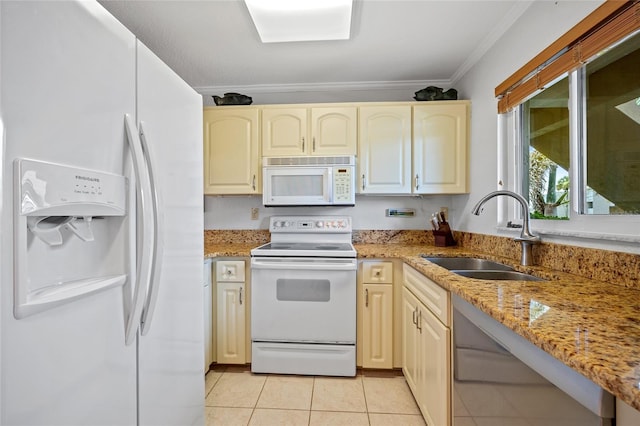 3221 White Ibis Ct Unit D1, Punta Gorda, FL 33950 - kitchen with white appliances, ornamental molding, light tile patterned flooring, light stone counters, and cream cabinets
