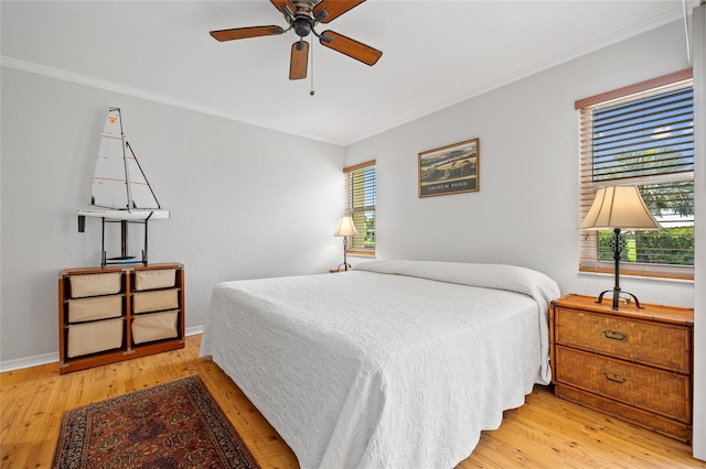 3221 White Ibis Ct Unit D1, Punta Gorda, FL 33950 - bedroom featuring crown molding, light wood-type flooring, and a ceiling fan