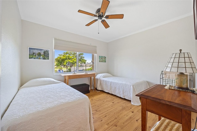 3221 White Ibis Ct Unit D1, Punta Gorda, FL 33950 - bedroom with light wood finished floors, crown molding, and a ceiling fan