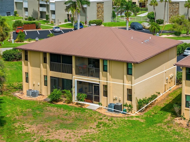 3221 White Ibis Ct Unit D1, Punta Gorda, FL 33950 - back of house with stucco siding, a lawn, and a metal roof