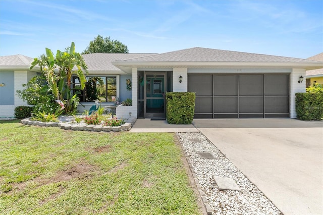 2141 Rio De Janeiro Ave, Punta Gorda, FL 33983 - ranch-style house with a garage, concrete driveway, a front lawn, roof with shingles, and brick siding