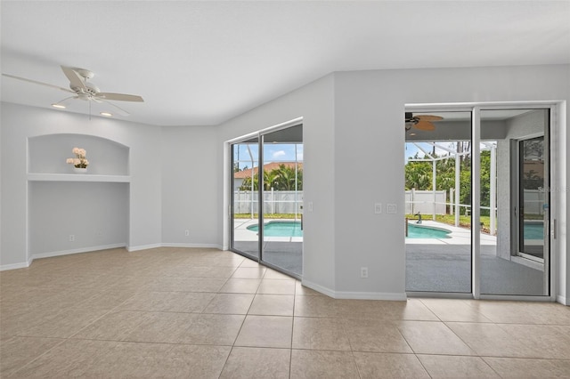 1762 Mincey Ter, North Port, FL 34286 - spare room featuring a ceiling fan, tile patterned flooring, and built in shelves