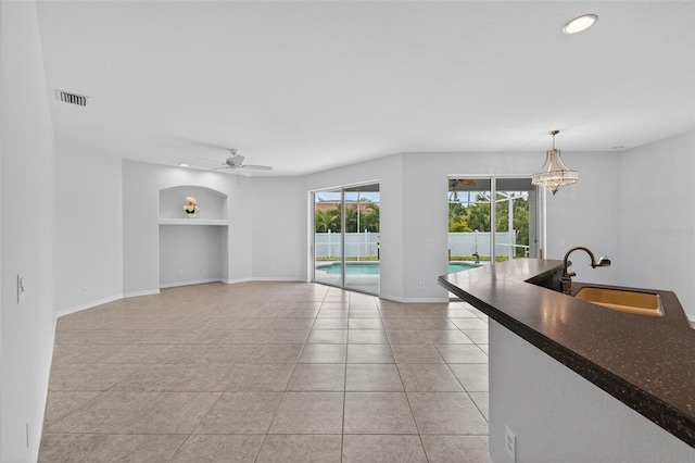 1762 Mincey Ter, North Port, FL 34286 - living area with built in shelves, light tile patterned flooring, recessed lighting, ceiling fan, and a chandelier