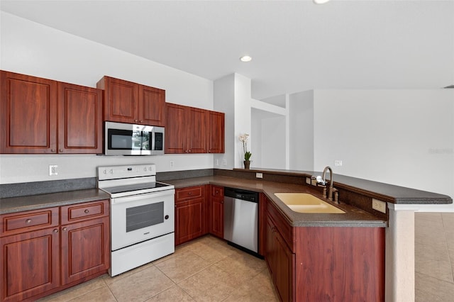 1762 Mincey Ter, North Port, FL 34286 - kitchen with appliances with stainless steel finishes, dark countertops, a peninsula, light tile patterned floors, and reddish brown cabinets