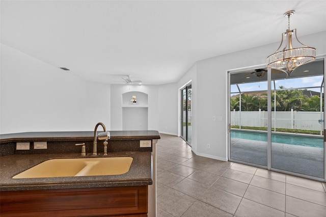 1762 Mincey Ter, North Port, FL 34286 - kitchen with a ceiling fan, built in features, dark countertops, tile patterned flooring, and pendant lighting