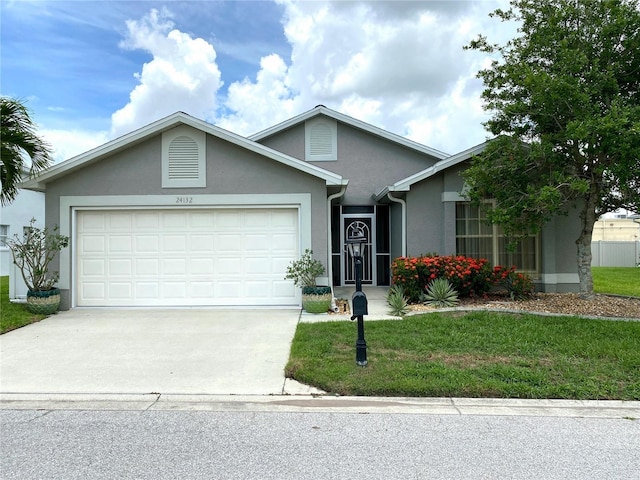 24132 Buckingham Way, Punta Gorda, FL 33980 - ranch-style home with stucco siding, an attached garage, driveway, and a front yard
