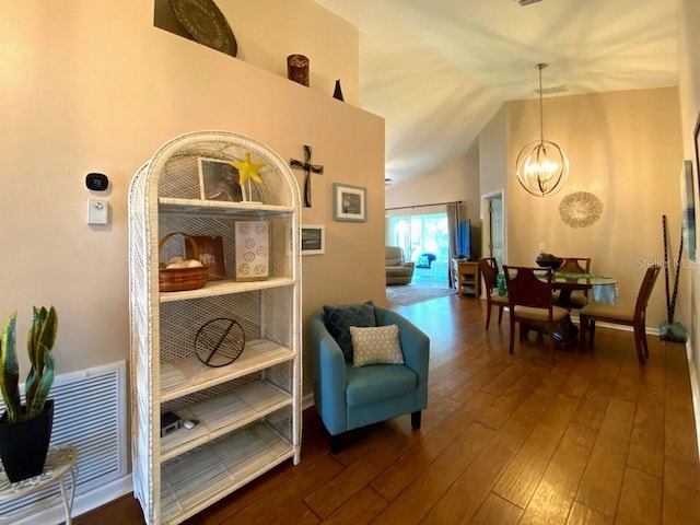 24132 Buckingham Way, Punta Gorda, FL 33980 - living area with a chandelier, hardwood / wood-style flooring, and vaulted ceiling