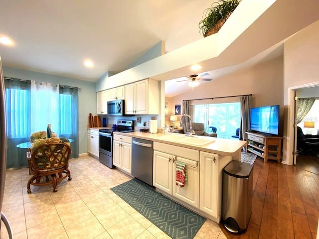 24132 Buckingham Way, Punta Gorda, FL 33980 - kitchen featuring appliances with stainless steel finishes, light countertops, a peninsula, a ceiling fan, and recessed lighting