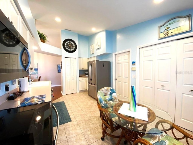 24132 Buckingham Way, Punta Gorda, FL 33980 - dining room with light tile patterned floors, a towering ceiling, and recessed lighting