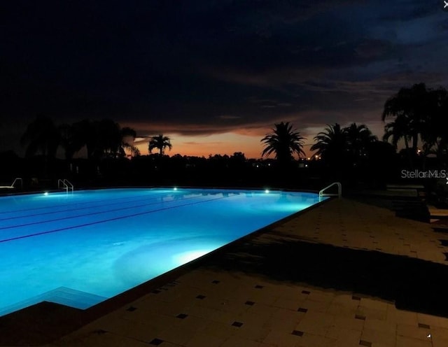 24132 Buckingham Way, Punta Gorda, FL 33980 - pool at dusk with a community pool and a patio area