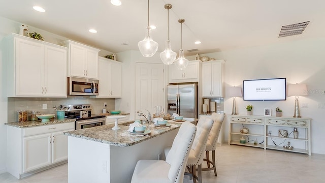 2308 Oberon Ln, Punta Gorda, FL 33983 - kitchen featuring appliances with stainless steel finishes, white cabinetry, decorative backsplash, and recessed lighting