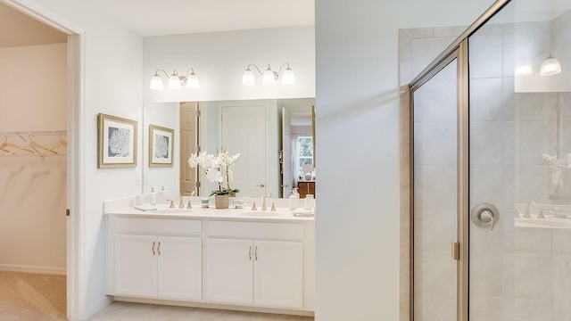 2308 Oberon Ln, Punta Gorda, FL 33983 - bathroom with double vanity, a shower stall, a walk in closet, and ensuite bathroom