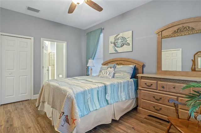 2712 Arugula Dr, North Port, FL 34289 - bedroom with wood finished floors, a ceiling fan, and connected bathroom