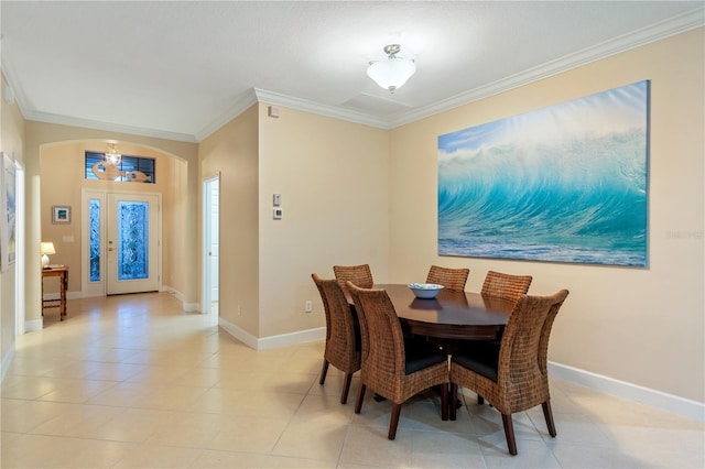 2712 Arugula Dr, North Port, FL 34289 - dining room featuring a chandelier, ornamental molding, light tile patterned floors, and arched walkways