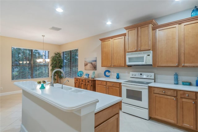 2712 Arugula Dr, North Port, FL 34289 - kitchen featuring white appliances, light tile patterned floors, light countertops, a chandelier, and recessed lighting