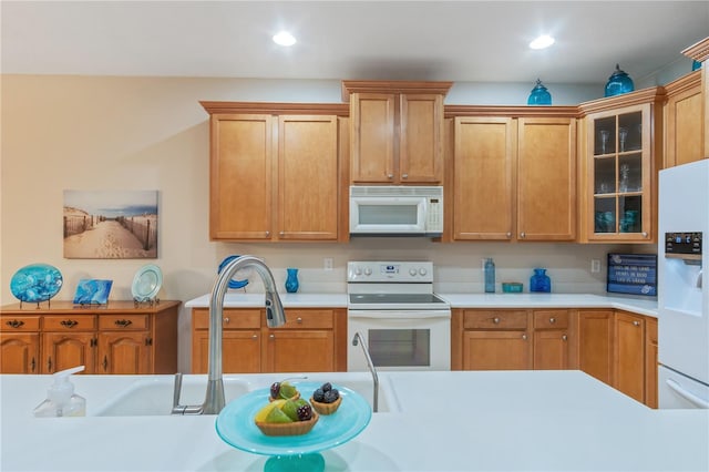 2712 Arugula Dr, North Port, FL 34289 - kitchen with white appliances, light countertops, glass insert cabinets, recessed lighting, and brown cabinetry