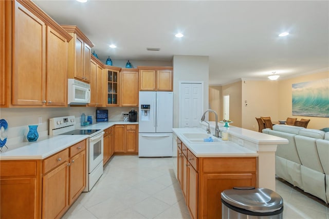 2712 Arugula Dr, North Port, FL 34289 - kitchen featuring white appliances, open floor plan, light countertops, glass insert cabinets, and a center island with sink