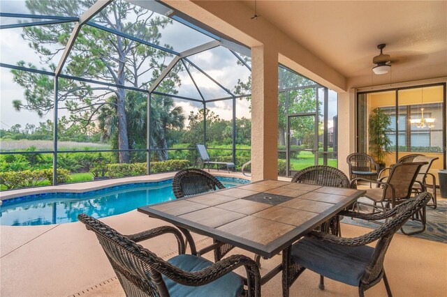 2712 Arugula Dr, North Port, FL 34289 - outdoor pool featuring a patio, glass enclosure, ceiling fan, and outdoor dining area