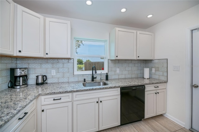 21539 Gladis Ave, Port Charlotte, FL 33952 - kitchen featuring black dishwasher, white cabinets, light wood-type flooring, tasteful backsplash, and recessed lighting