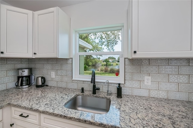 21539 Gladis Ave, Port Charlotte, FL 33952 - kitchen featuring white cabinetry, backsplash, and light stone counters