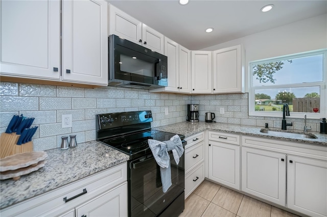 21539 Gladis Ave, Port Charlotte, FL 33952 - kitchen with black appliances, white cabinetry, light stone counters, and recessed lighting