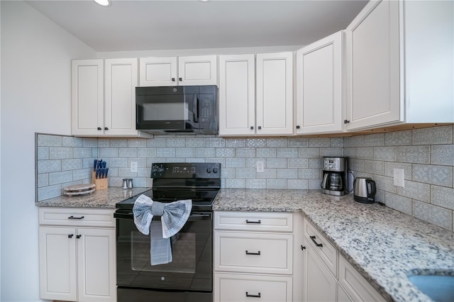 21539 Gladis Ave, Port Charlotte, FL 33952 - kitchen with black appliances, white cabinets, and light stone counters