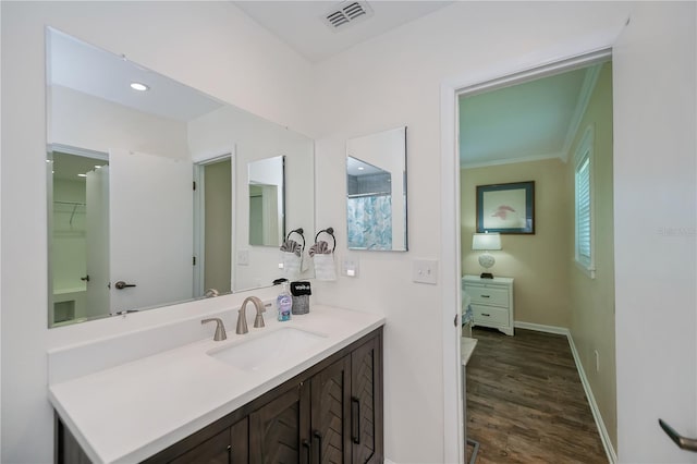 21539 Gladis Ave, Port Charlotte, FL 33952 - bathroom featuring vanity, wood finished floors, and ornamental molding