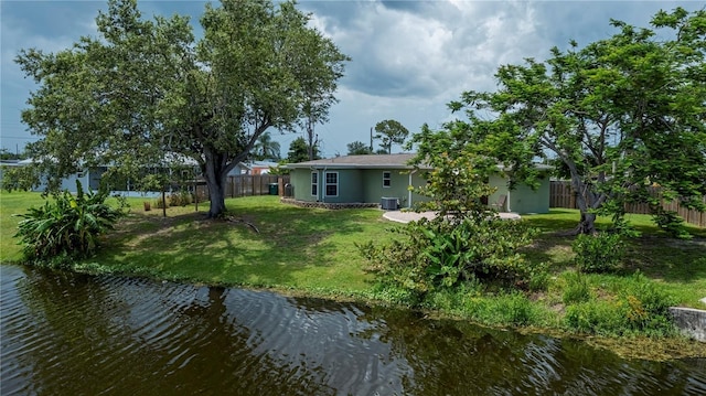 21539 Gladis Ave, Port Charlotte, FL 33952 - back of property with a fenced backyard, stucco siding, and a water view