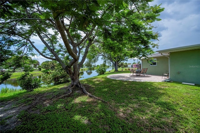 21539 Gladis Ave, Port Charlotte, FL 33952 - view of green lawn with a water view and a patio