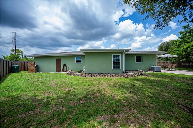 21539 Gladis Ave, Port Charlotte, FL 33952 - back of house with stucco siding, a fenced backyard, and a patio