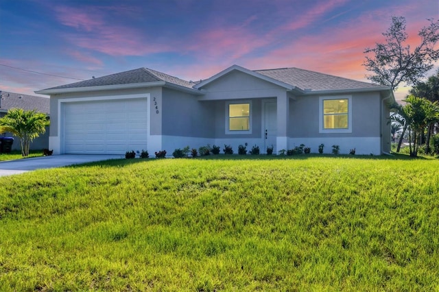 2340 Rushmore St, North Port, FL 34288 - single story home featuring a garage, stucco siding, driveway, and a yard