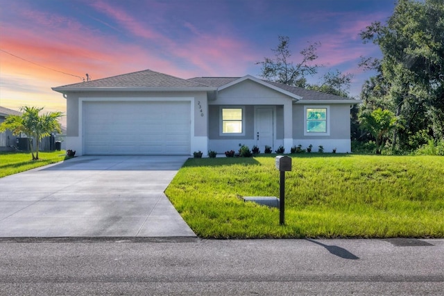2340 Rushmore St, North Port, FL 34288 - ranch-style home featuring driveway, an attached garage, a lawn, and stucco siding