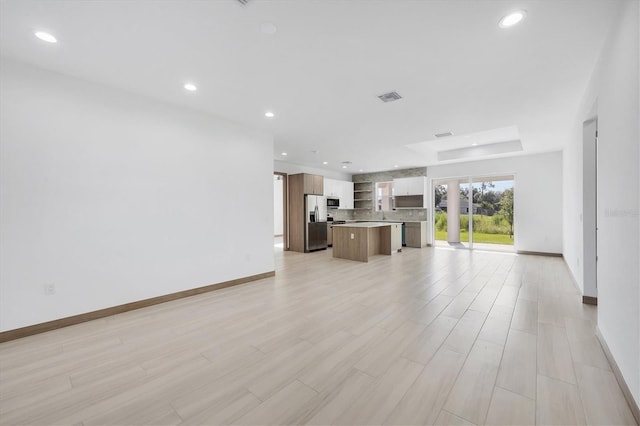 2340 Rushmore St, North Port, FL 34288 - unfurnished living room with recessed lighting and light wood-style flooring