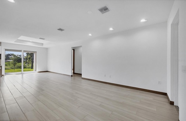 2340 Rushmore St, North Port, FL 34288 - spare room with recessed lighting, light wood finished floors, and a tray ceiling