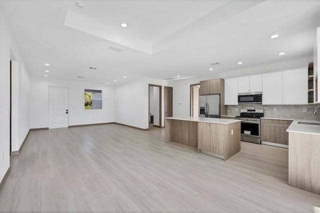 2340 Rushmore St, North Port, FL 34288 - kitchen with appliances with stainless steel finishes, a kitchen island, modern cabinets, open floor plan, and recessed lighting