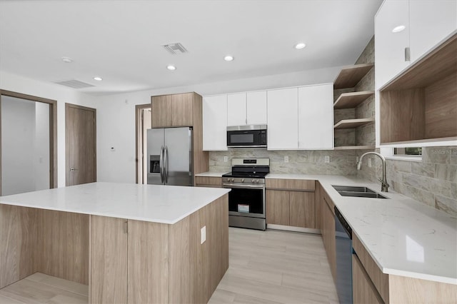 2340 Rushmore St, North Port, FL 34288 - kitchen with stainless steel appliances, open shelves, modern cabinets, white cabinetry, and decorative backsplash