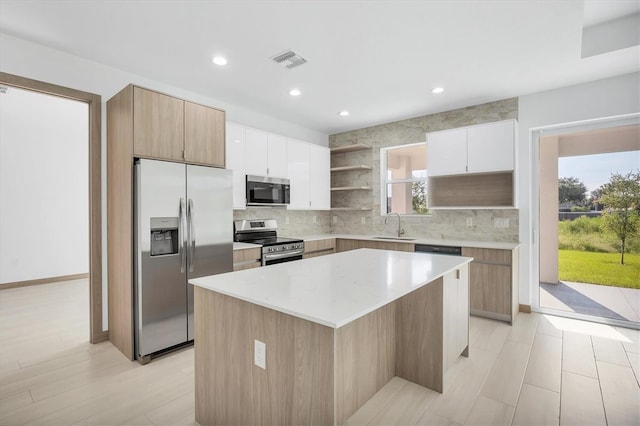 2340 Rushmore St, North Port, FL 34288 - kitchen featuring stainless steel appliances, open shelves, a kitchen island, tasteful backsplash, and recessed lighting